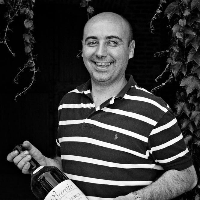 Winemaker Fabio Alessandria with a bottle of Comm. G.B. Burlotto Barolo