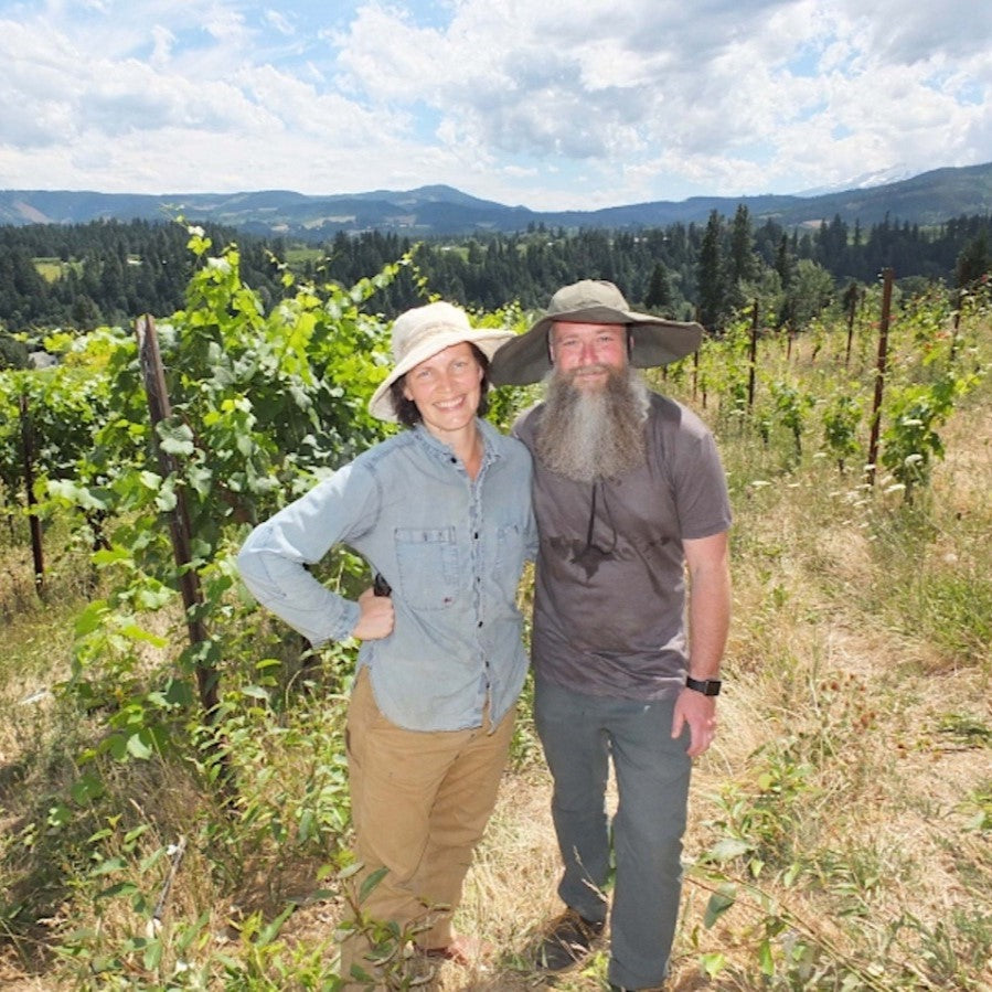 China Tresemer & Nate Ready standing in the vineyard